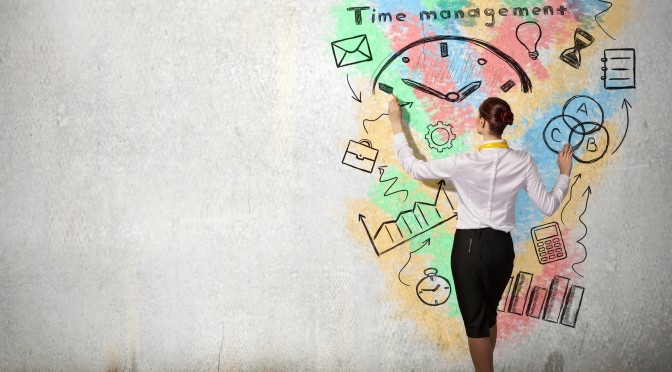 Back view of businesswoman drawing time management concept on wall